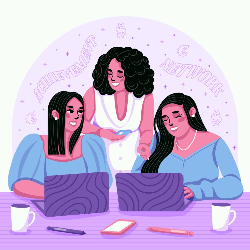 women in front of two laptops